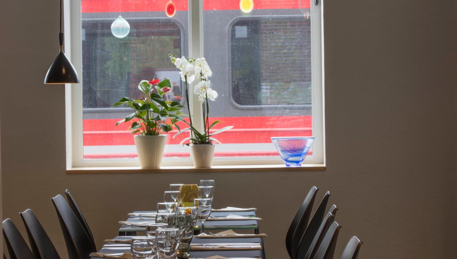 Long table set for customers at Stasjonen Cafe & Restaurant
