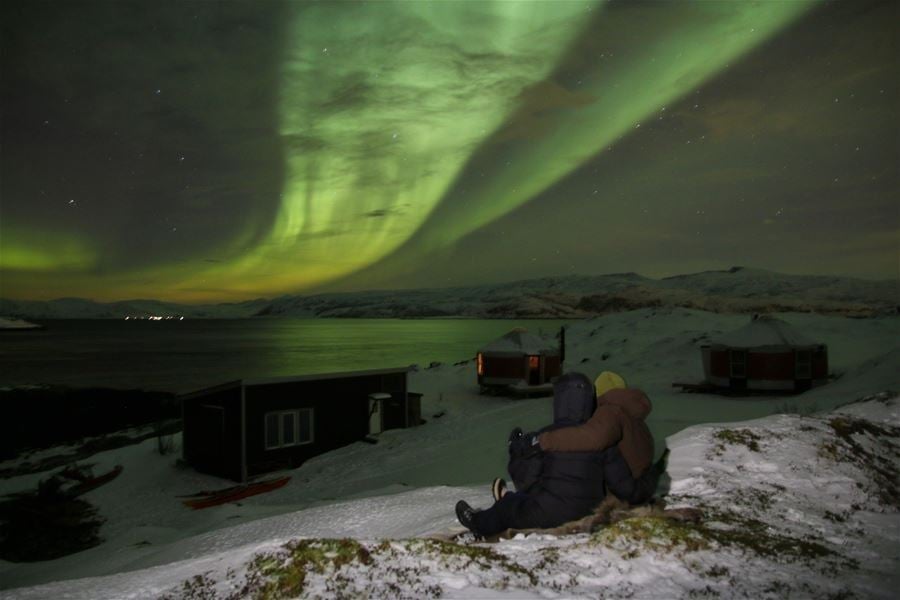 A couple looking at the northern lights