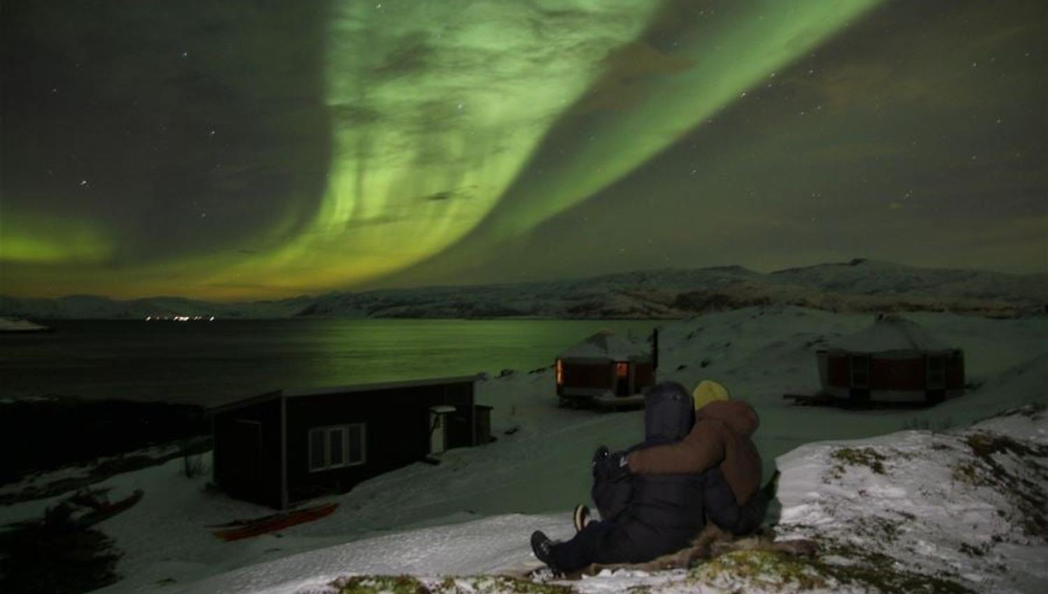 A couple looking at the northern lights