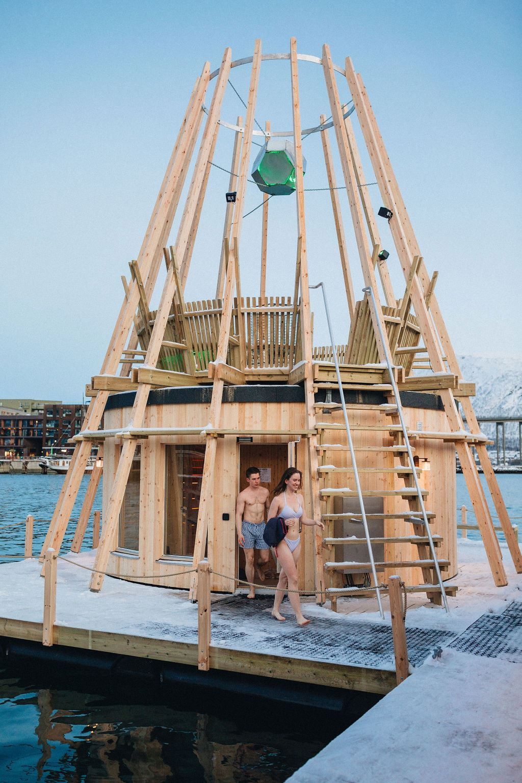 Two people coming out of a sauna during winter