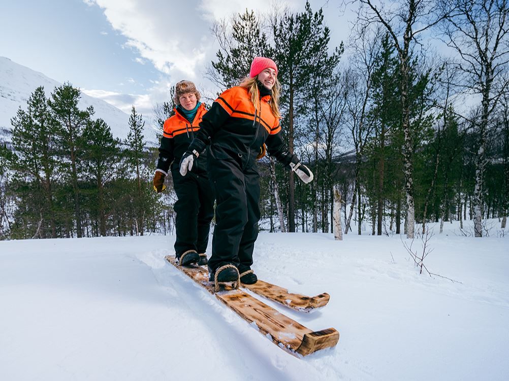Guests trying tandem skiing in the snow at Camp Tamok