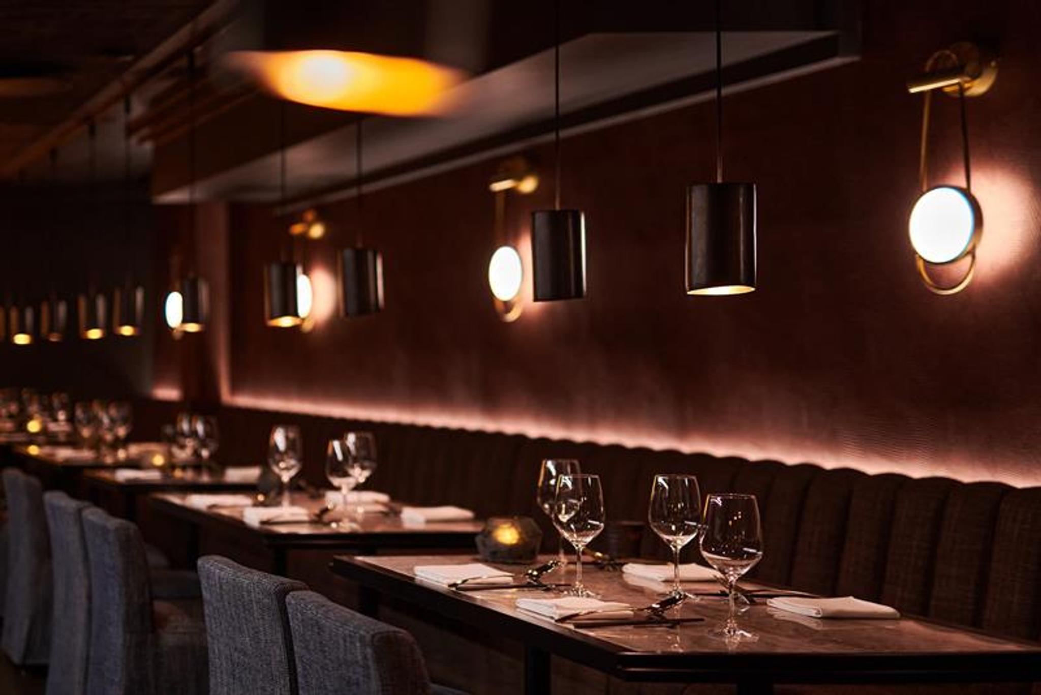 Table set for dining and seating section against the wall