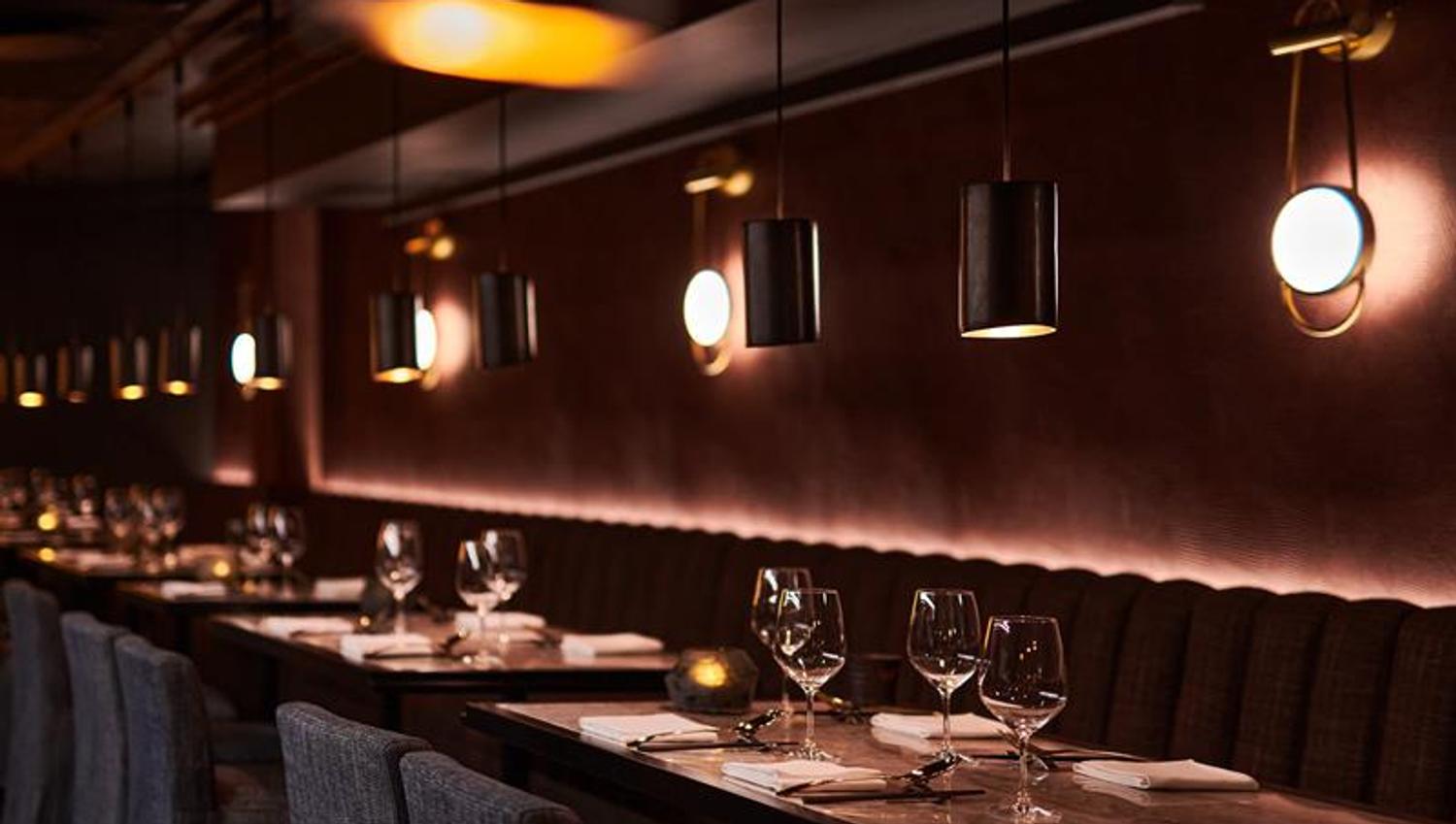 Table set for dining and seating section against the wall
