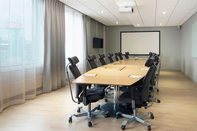 conference room with a large conference table and projector with screen