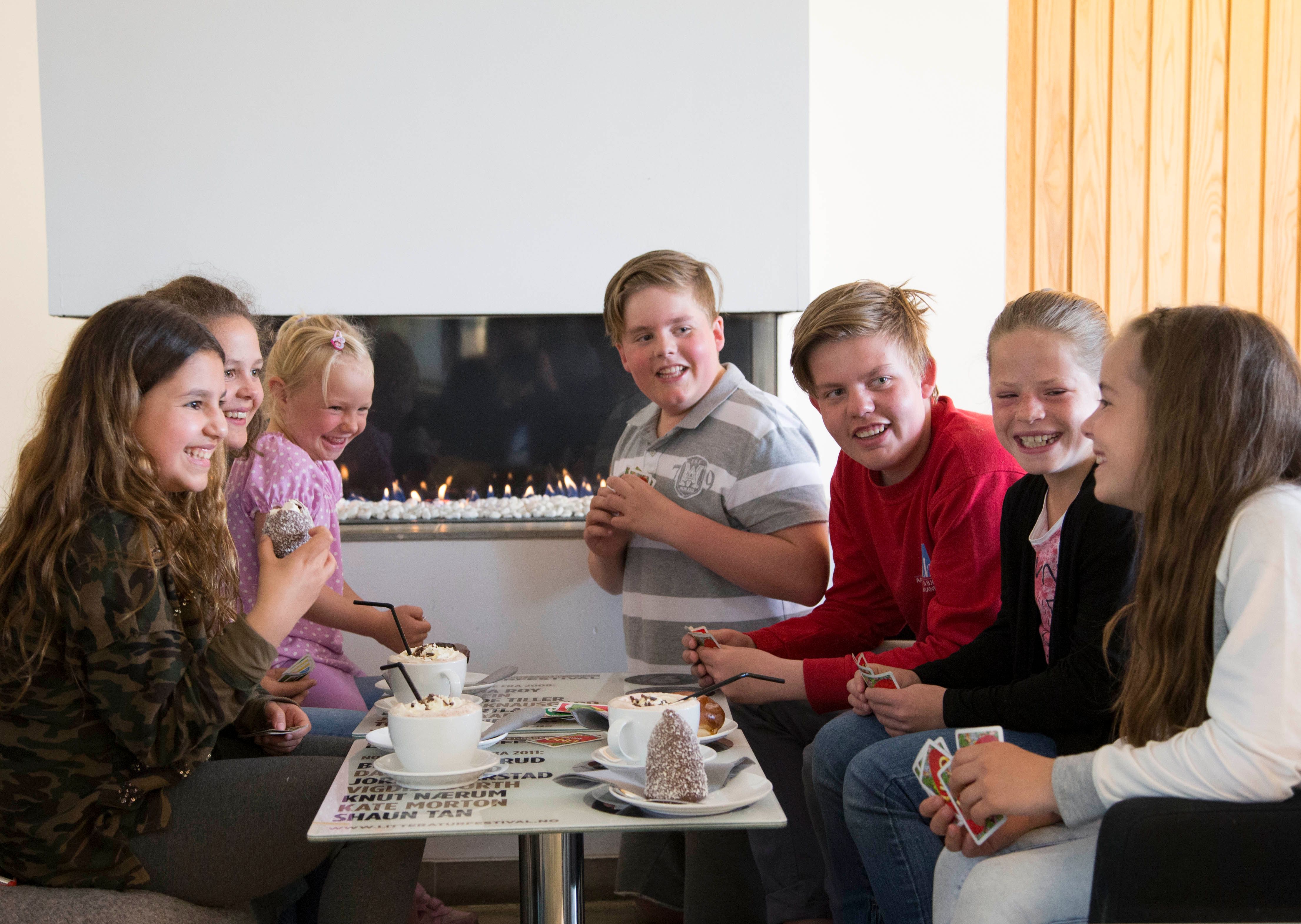 Kids enjoying hot chocolate and desserts at Stasjonen Cafe & Restaurant