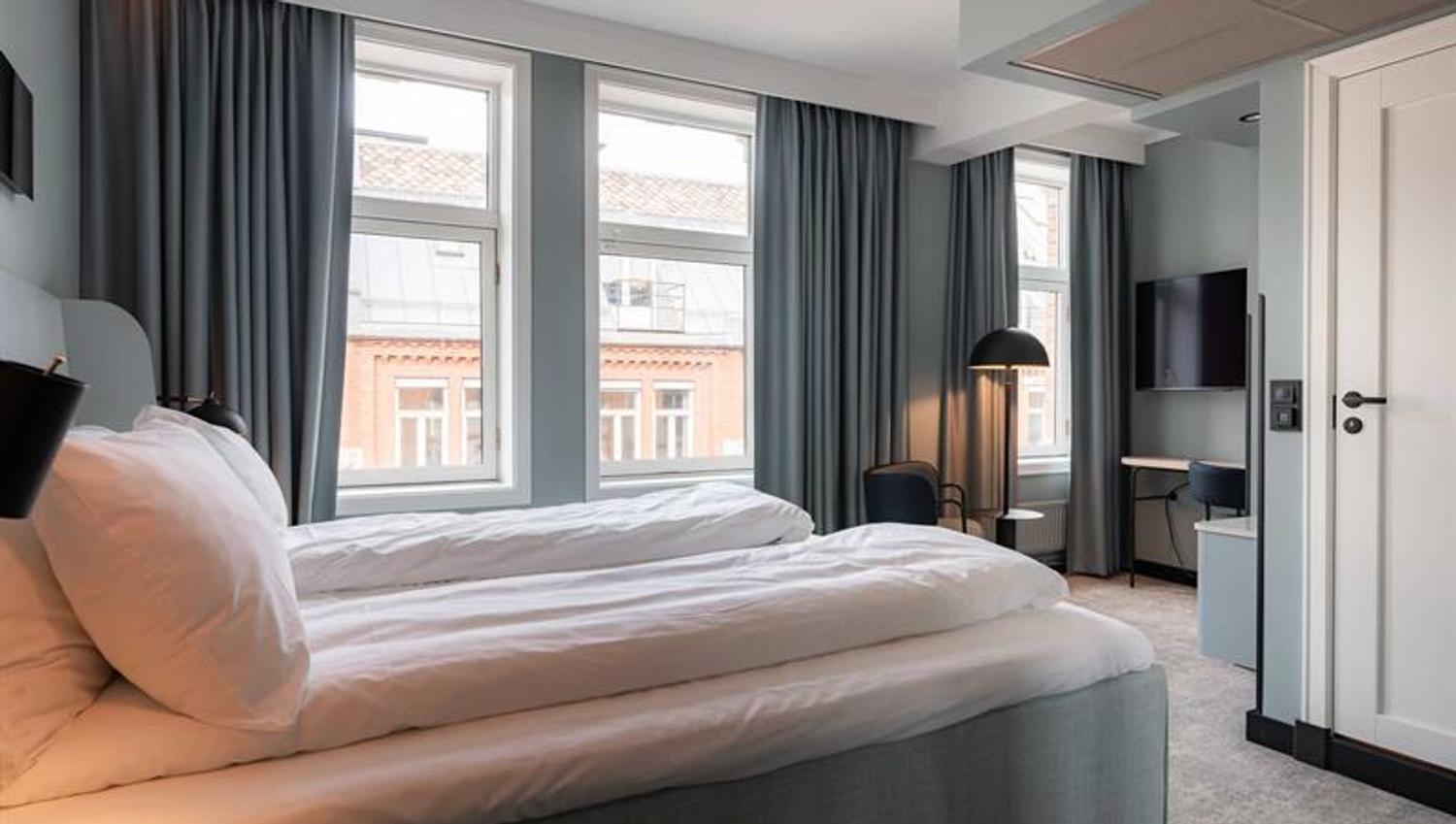 Hotel room with two single beds and view of the street