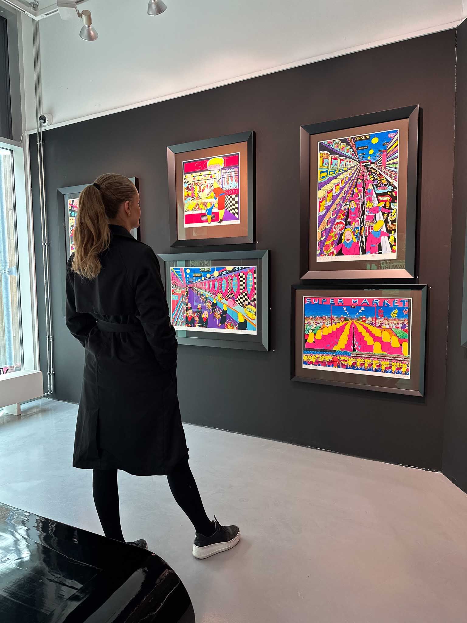 Girl looking at exhibited Pushwagner pictures