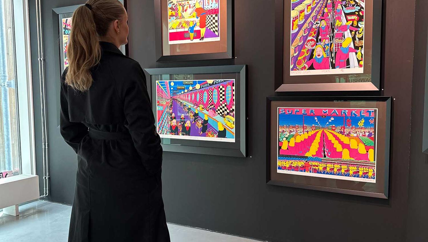 Girl looking at exhibited Pushwagner pictures