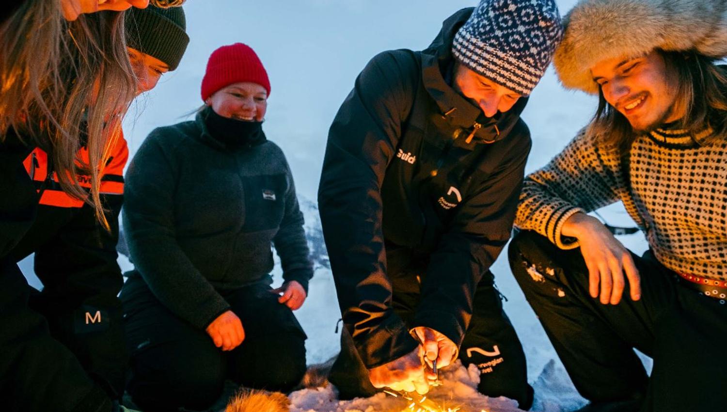 Group gathered around a campfire during a winter experience at Camp Tamok