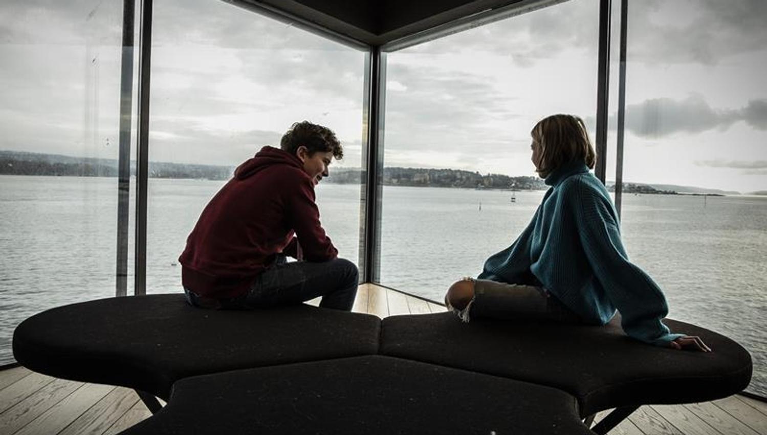 Two children at the window out to the Oslo Fjord