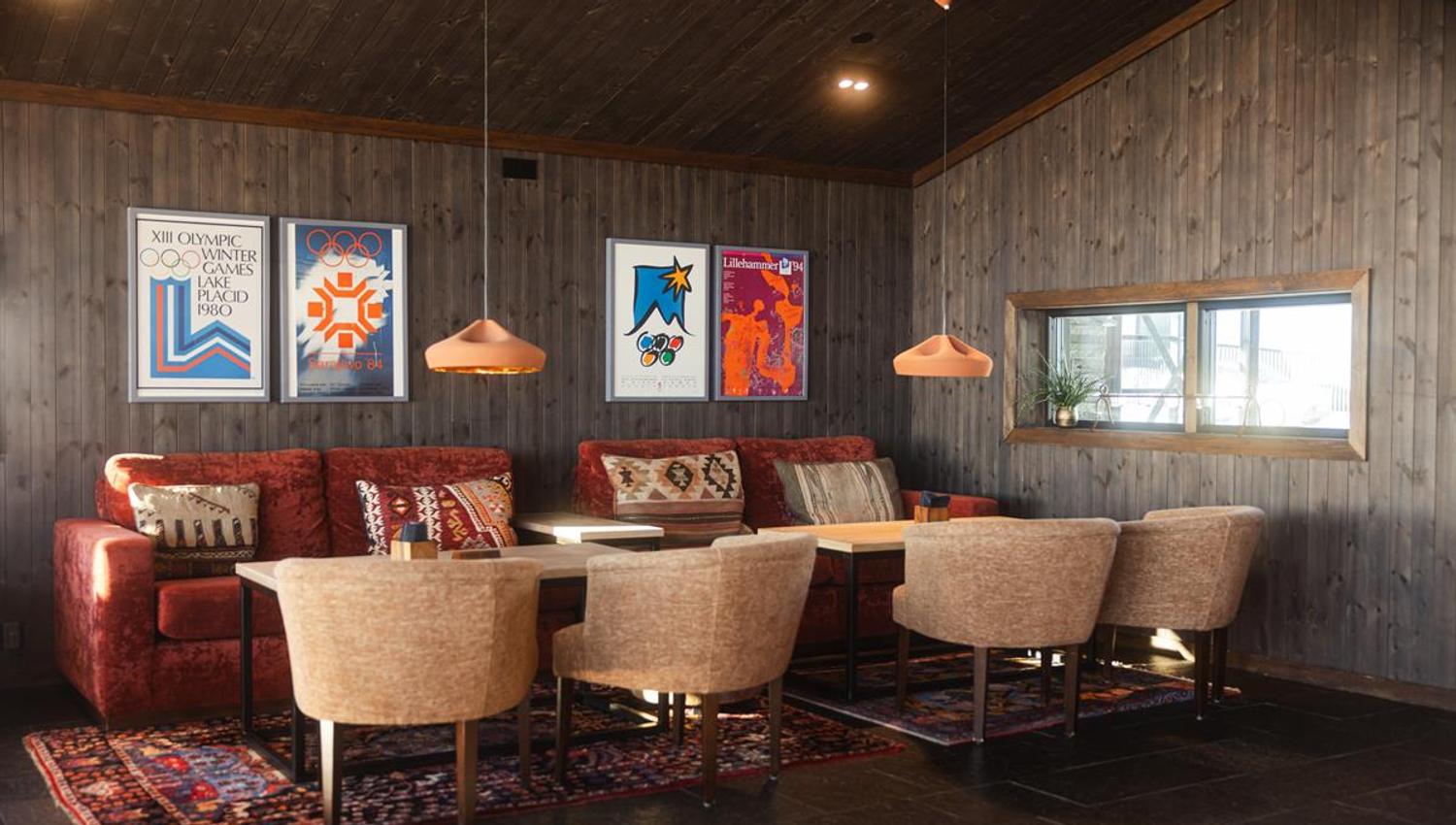 Restaurant interior with fireplace, artwork and seating areas.