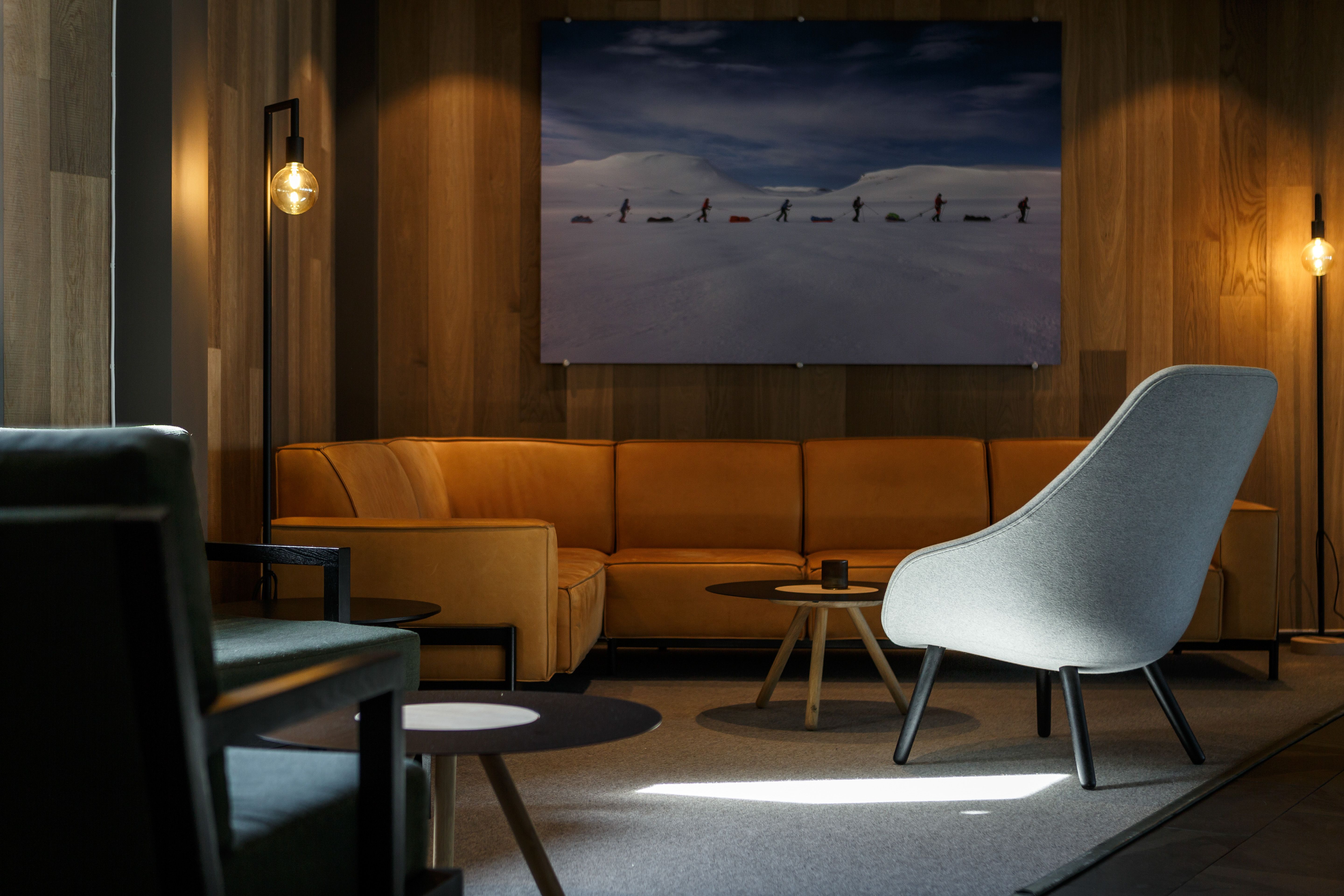 A lounge area with a large photo of people skiing in the background.