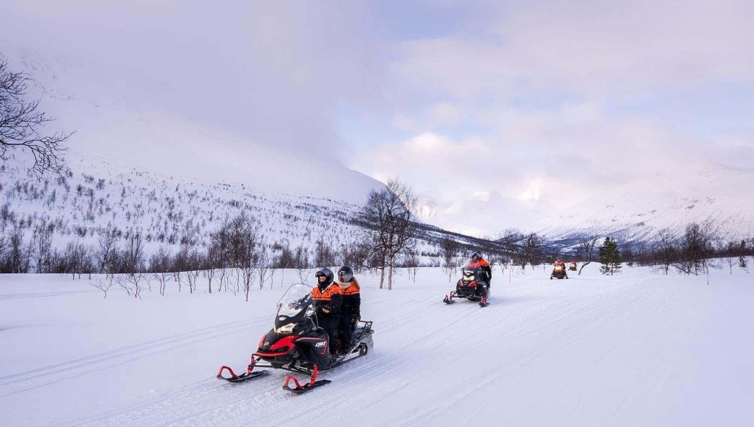 Snow scooter trip through the forest