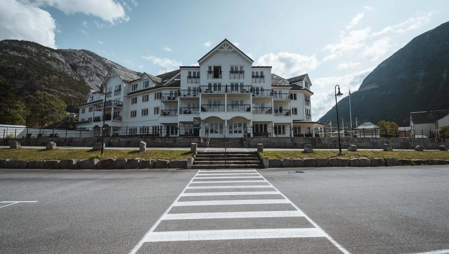 Vøringfoss Hotel seen from the harbour area on a sunny day.