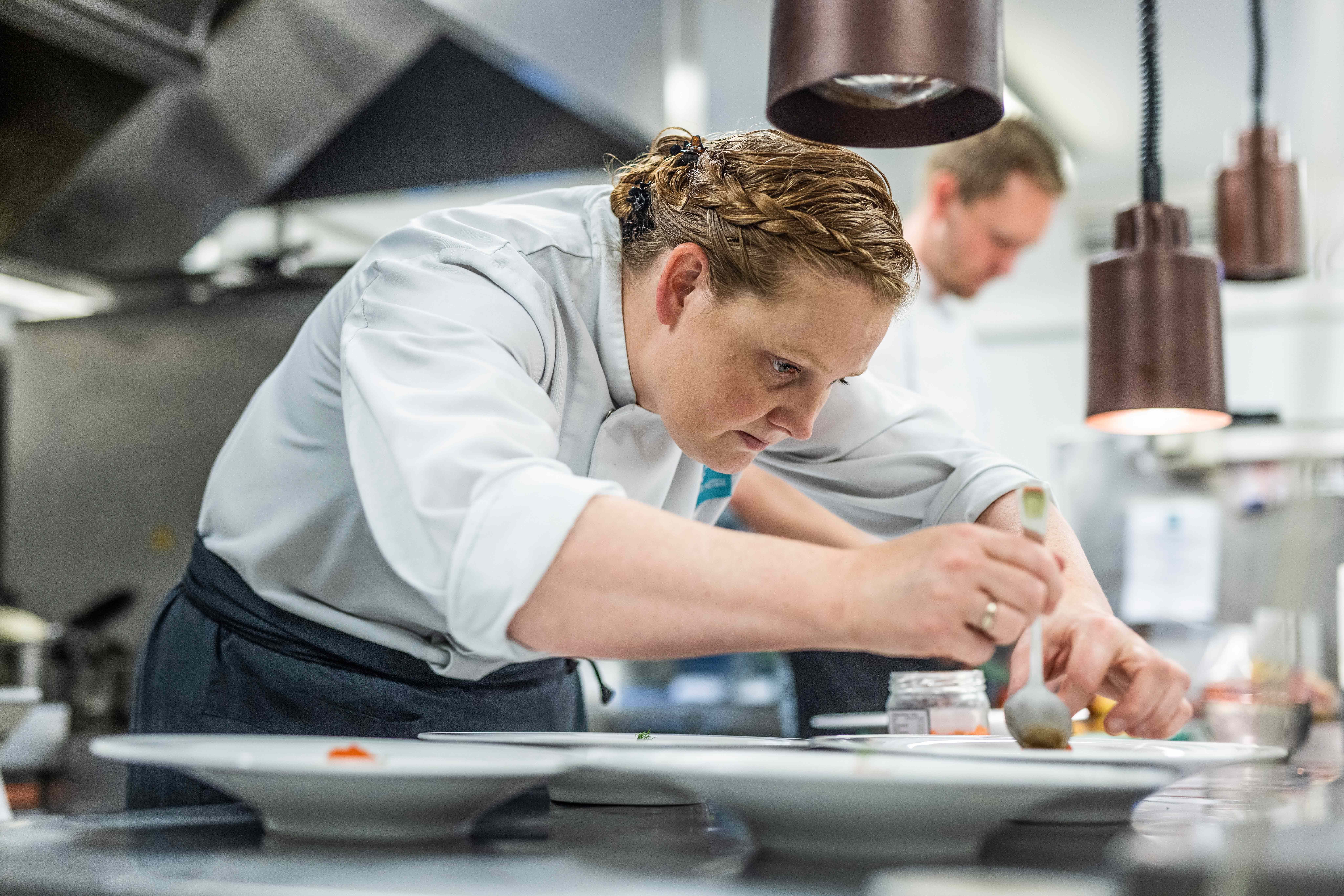 Chef preparing food in the kitchen at Restaurant Stovene at Gloppen Hotel in Sandane, Nordfjord.