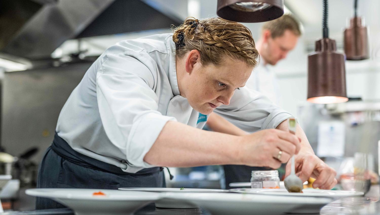 Chef preparing food in the kitchen at Restaurant Stovene at Gloppen Hotel in Sandane, Nordfjord.