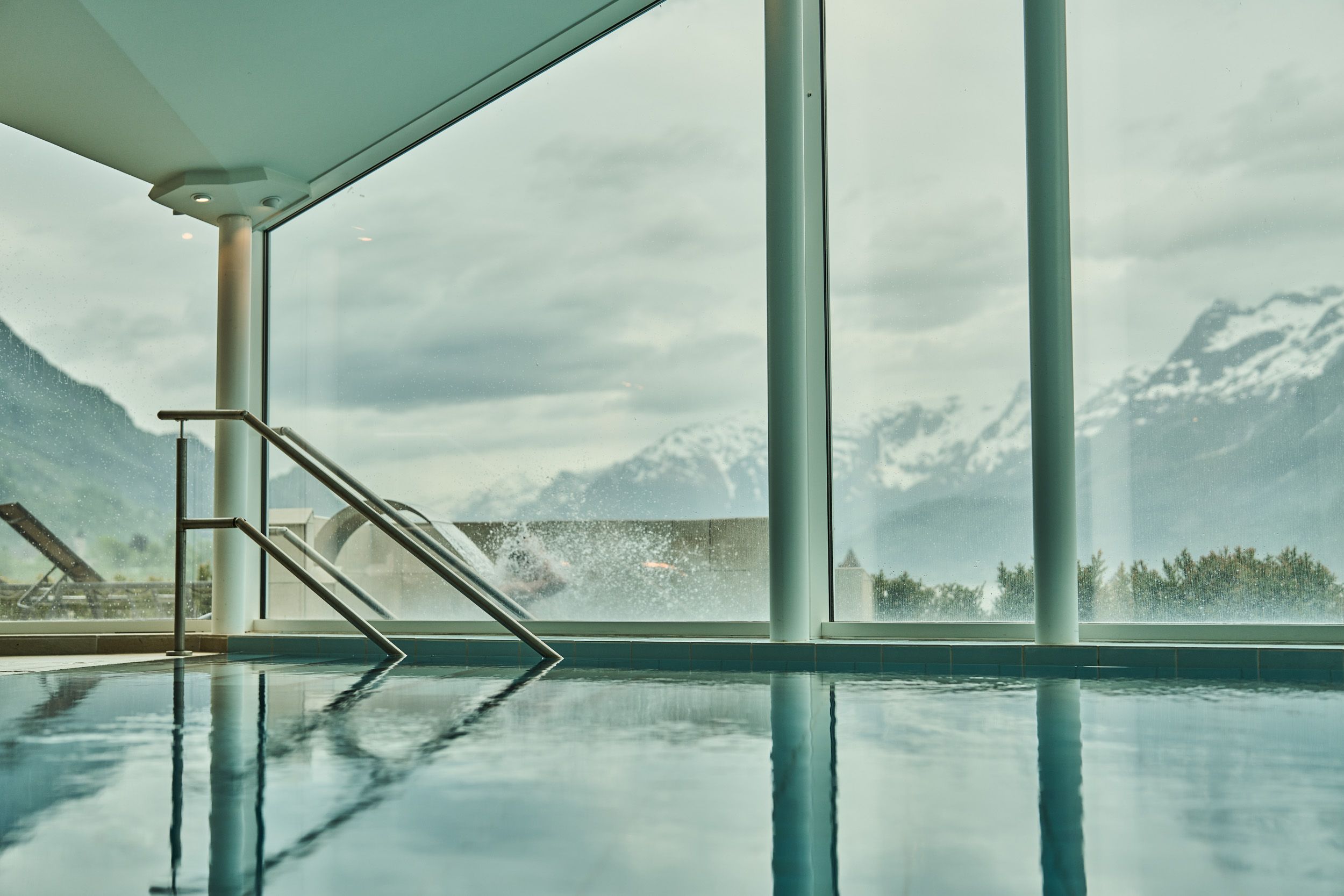 Indoor pool with panoramic view of mountains and fjord at Hotel Ullensvang.