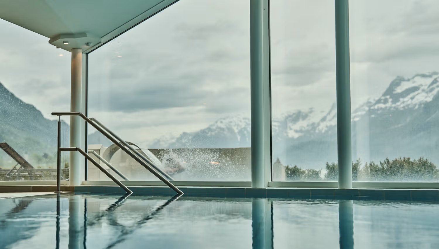 Indoor pool with panoramic view of mountains and fjord at Hotel Ullensvang.