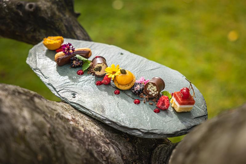Dessert plate with chocolate and macrons on a stone plate