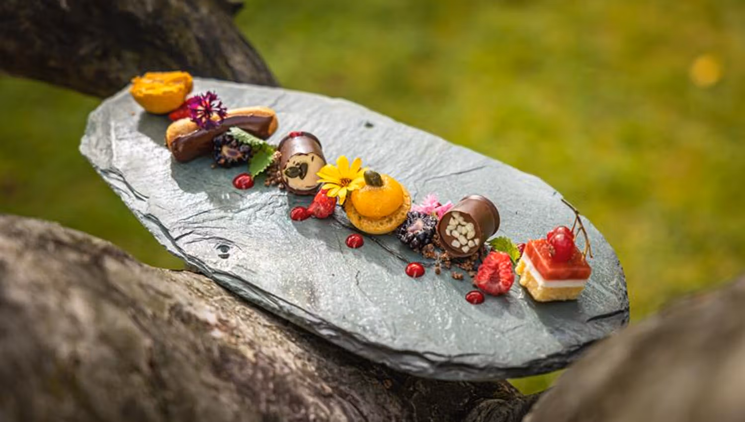 Dessert plate with chocolate and macrons on a stone plate