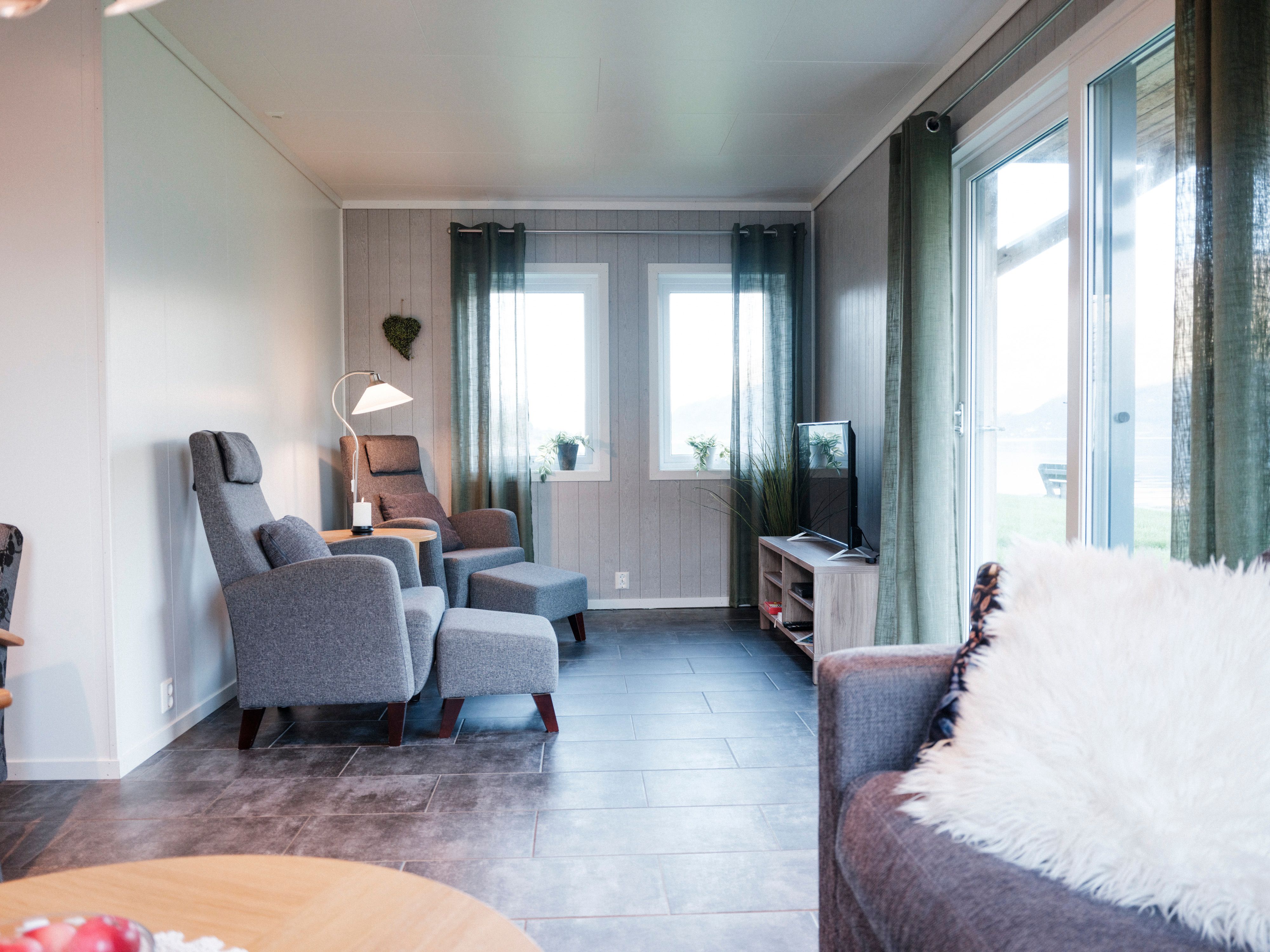 Living room view from Aga Fjordapartments overlooking the Hardangerfjord and mountains.