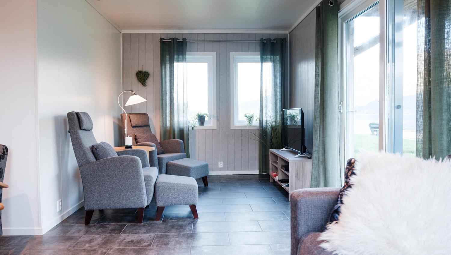 Living room view from Aga Fjordapartments overlooking the Hardangerfjord and mountains.