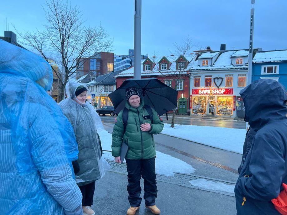 Guests on a guided walking tour through Tromsø city centre, exploring local history, Sami culture and mythology.