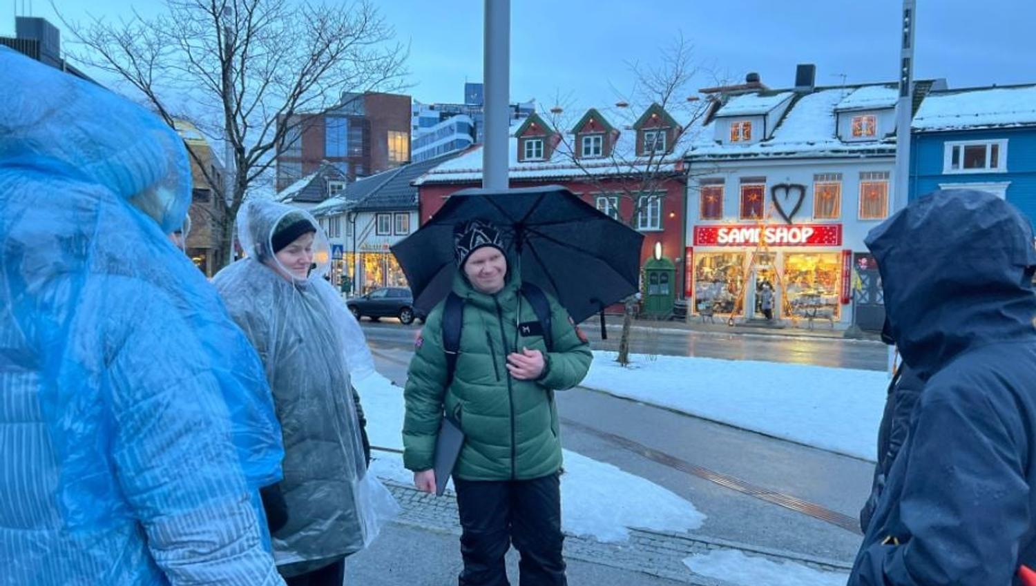 Guests on a guided walking tour through Tromsø city centre, exploring local history, Sami culture and mythology.