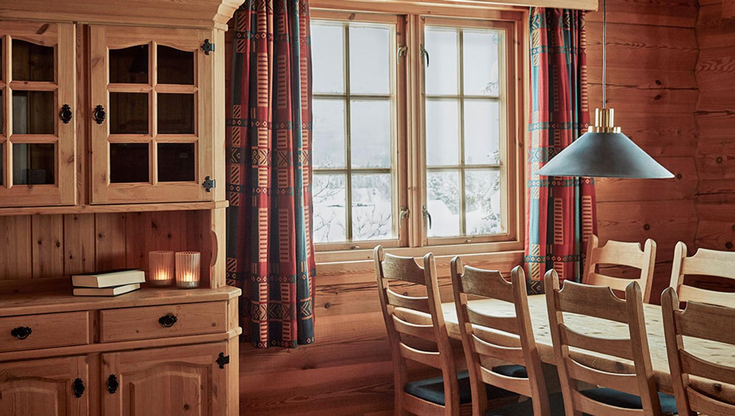 dining table by the window at the cottage at Gaustablikk Fjellresort
