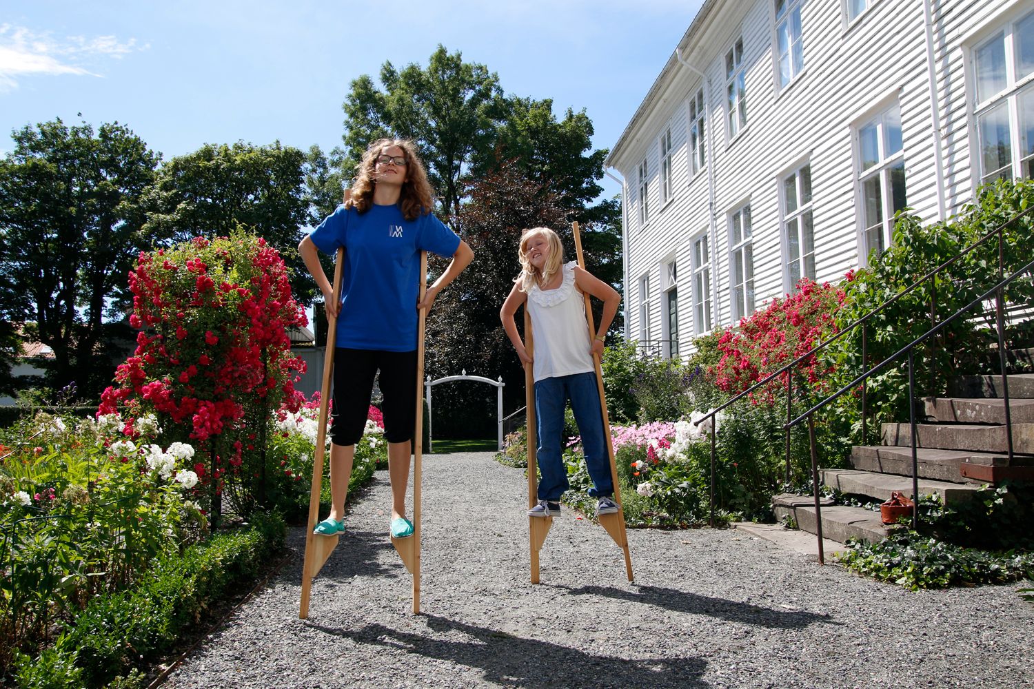 Two people walking on stilts at Andorsen Farm.