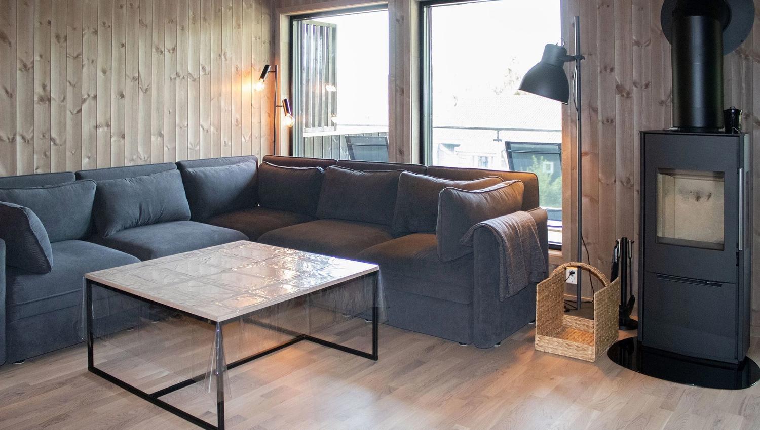 A living room with a sofa and a glass table.