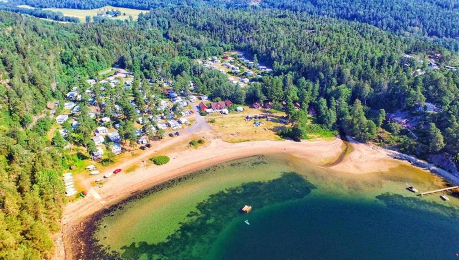 Drone photo of Knatvoldstranda camping with sand beach and surrounded by green forest