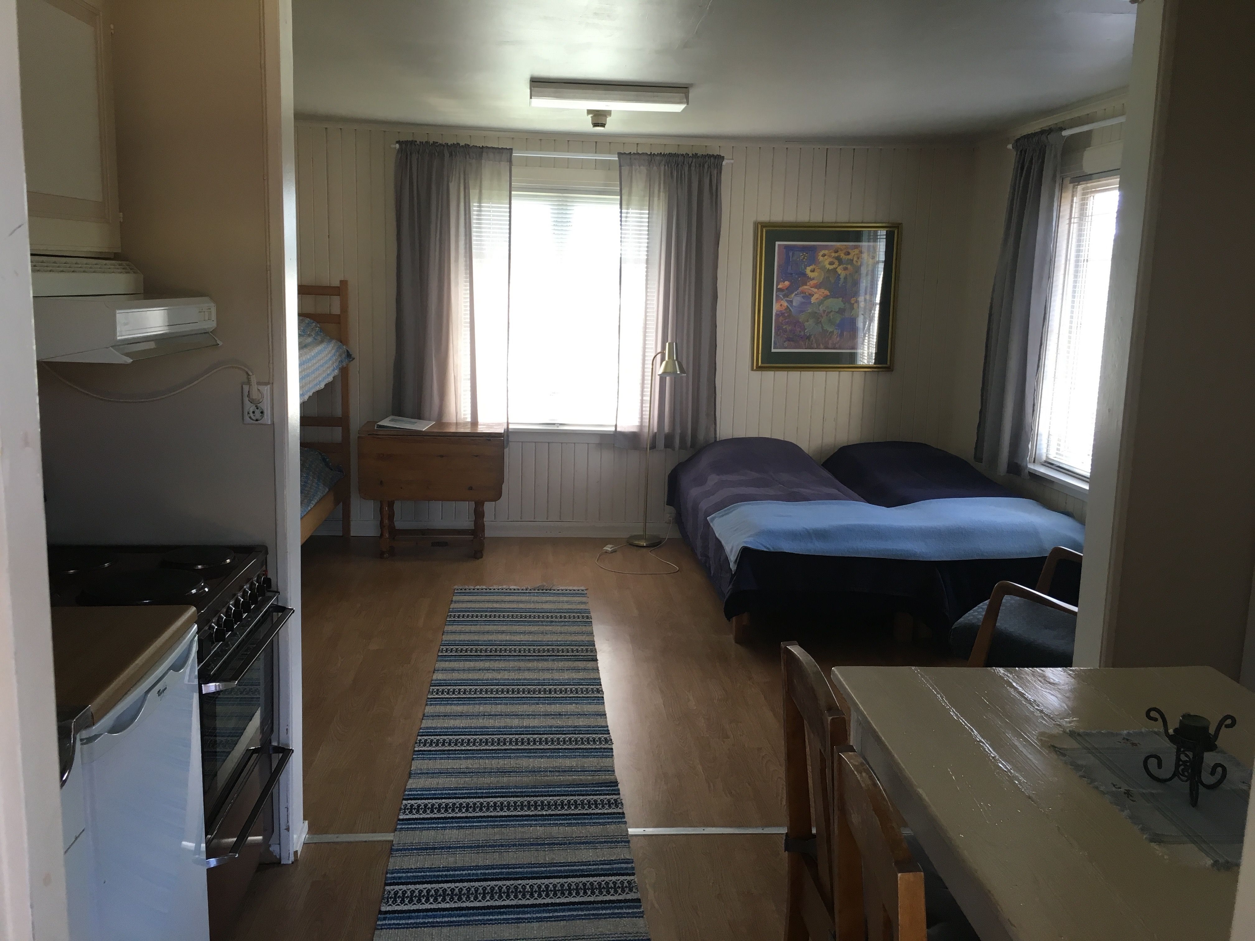 Room with beds and kitchen