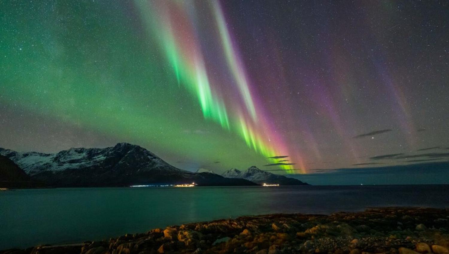 Northern lights reflects itself in the fjords