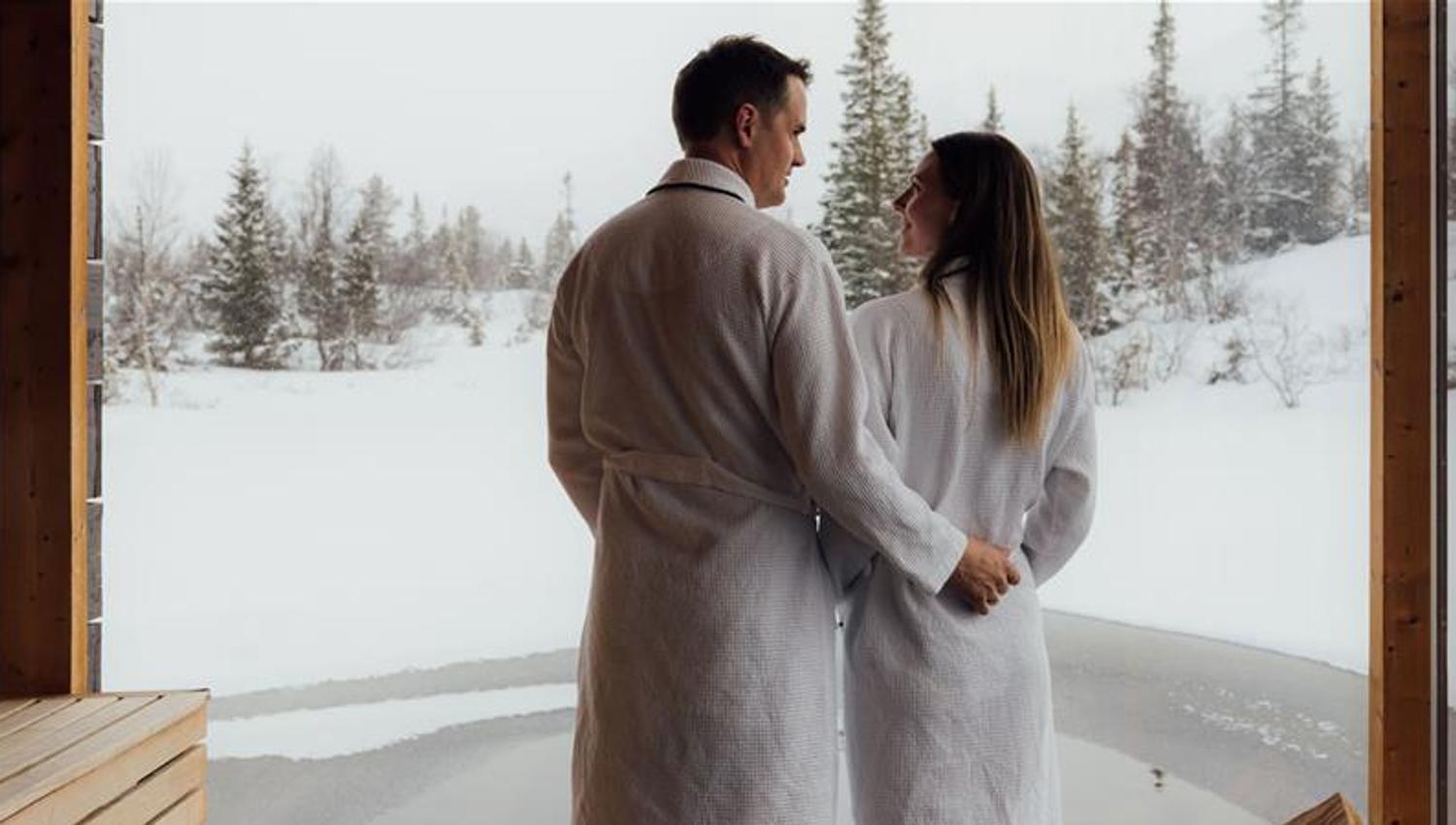 couple on a floating sauna in winter