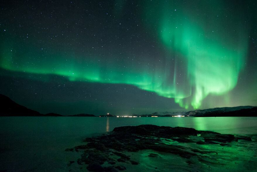 Northern lights above the sea in the Tromso region