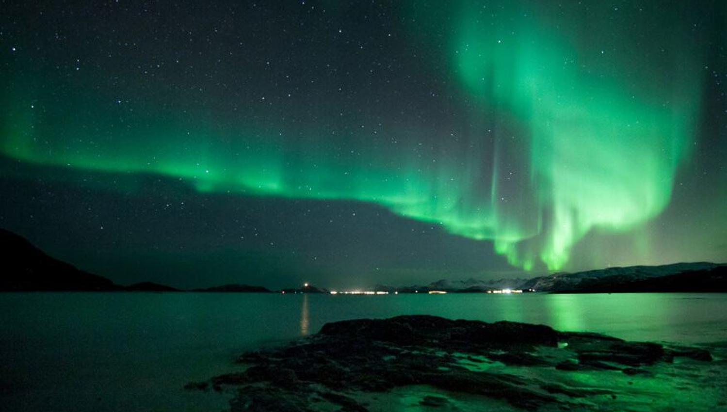 Northern lights above the sea in the Tromso region
