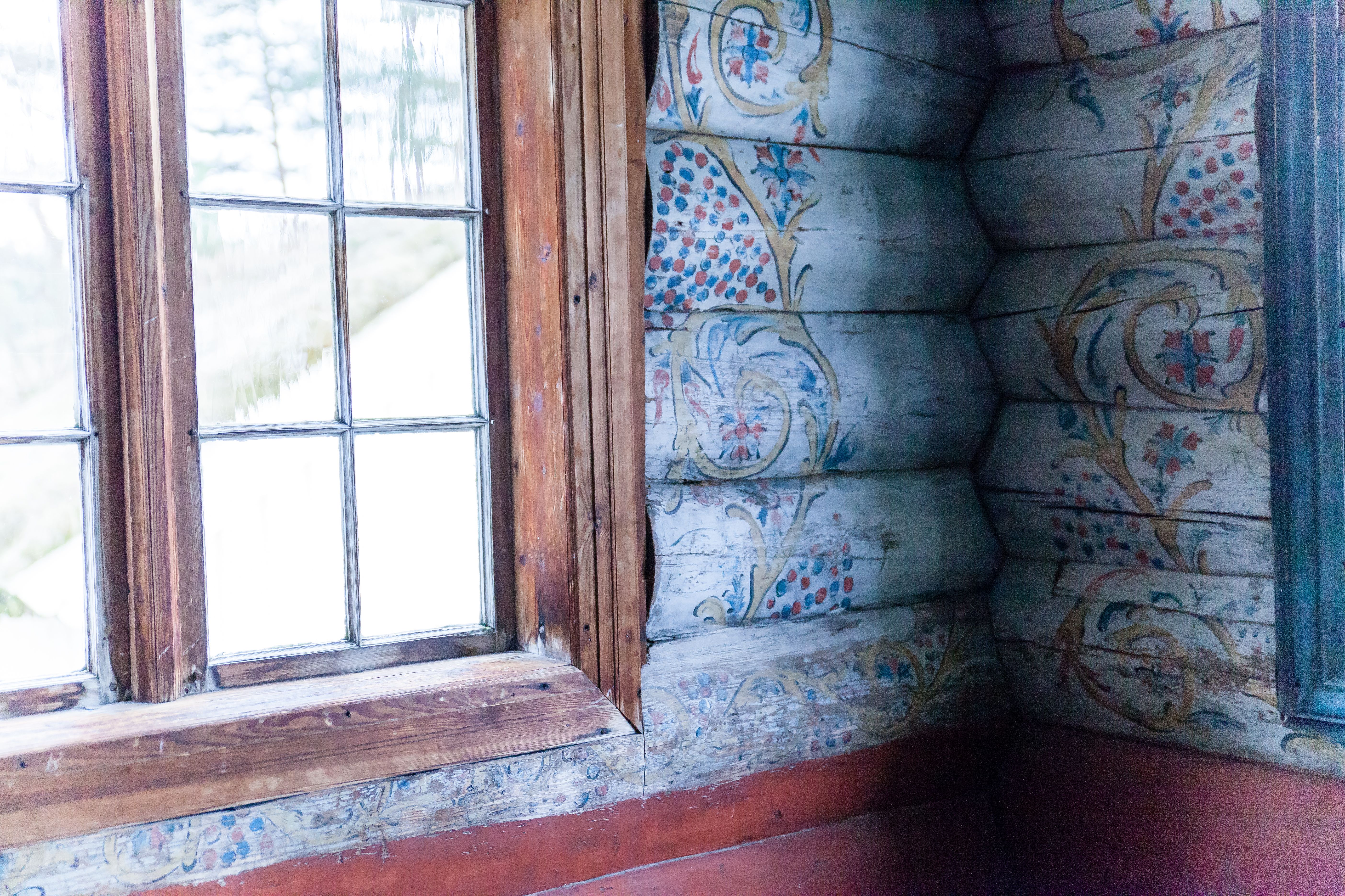 Marnardal Museum and Mjålandsstova, white-painted timber walls with colorful details in traditional rosemaling.