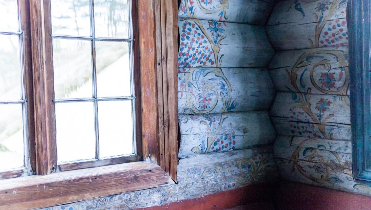Marnardal Museum and Mjålandsstova, white-painted timber walls with colorful details in traditional rosemaling.