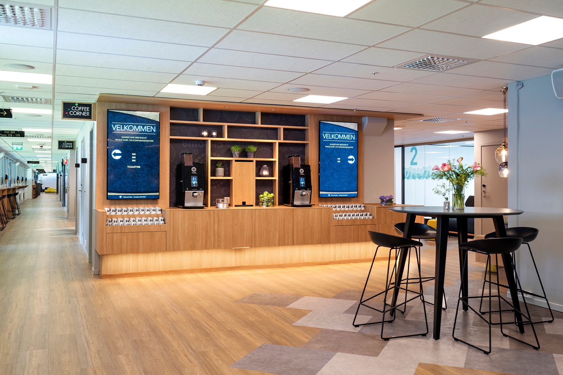 Coffee machines and a small table with bar stools.