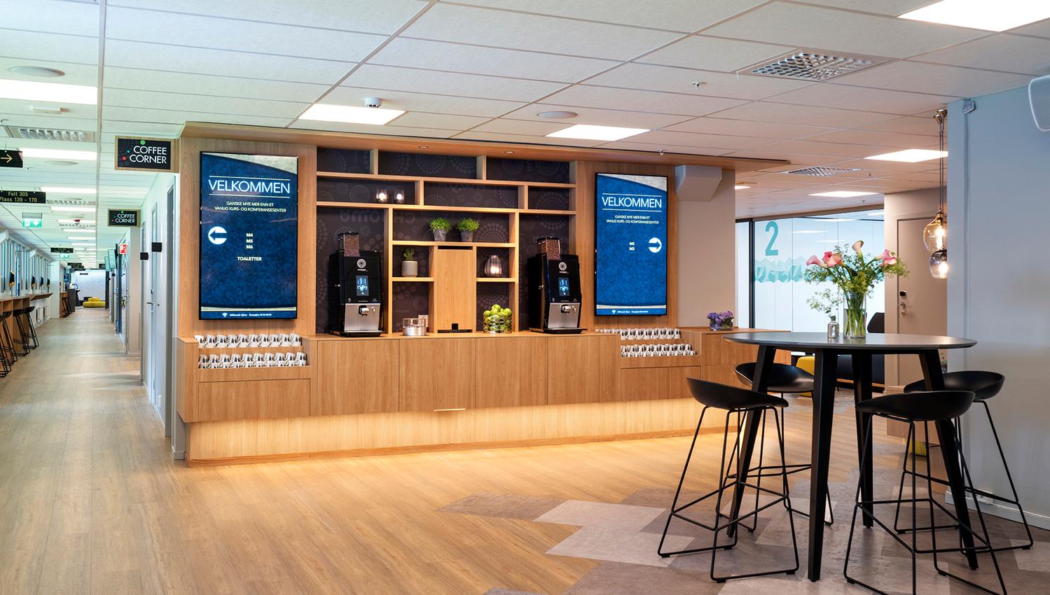 Coffee machines and a small table with bar stools.
