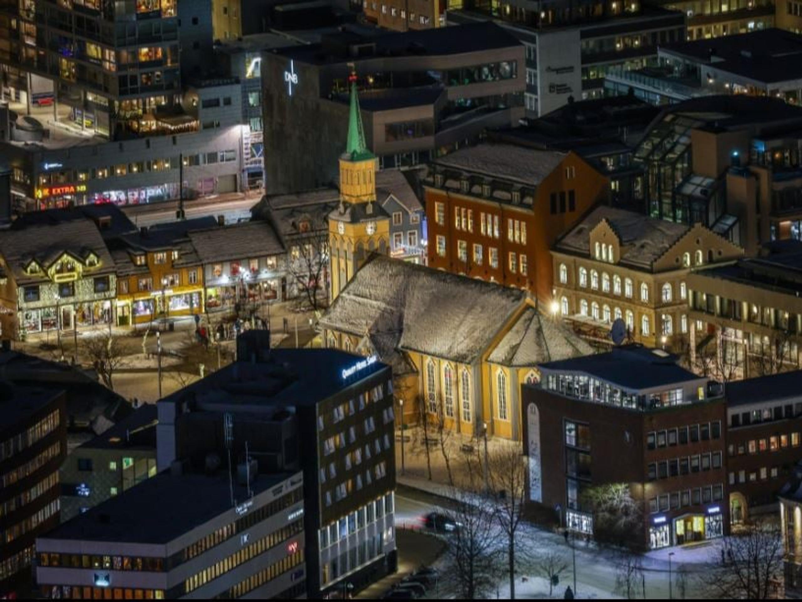 Evening view over Tromsø city centre, part of the area explored during the historical walking tour.