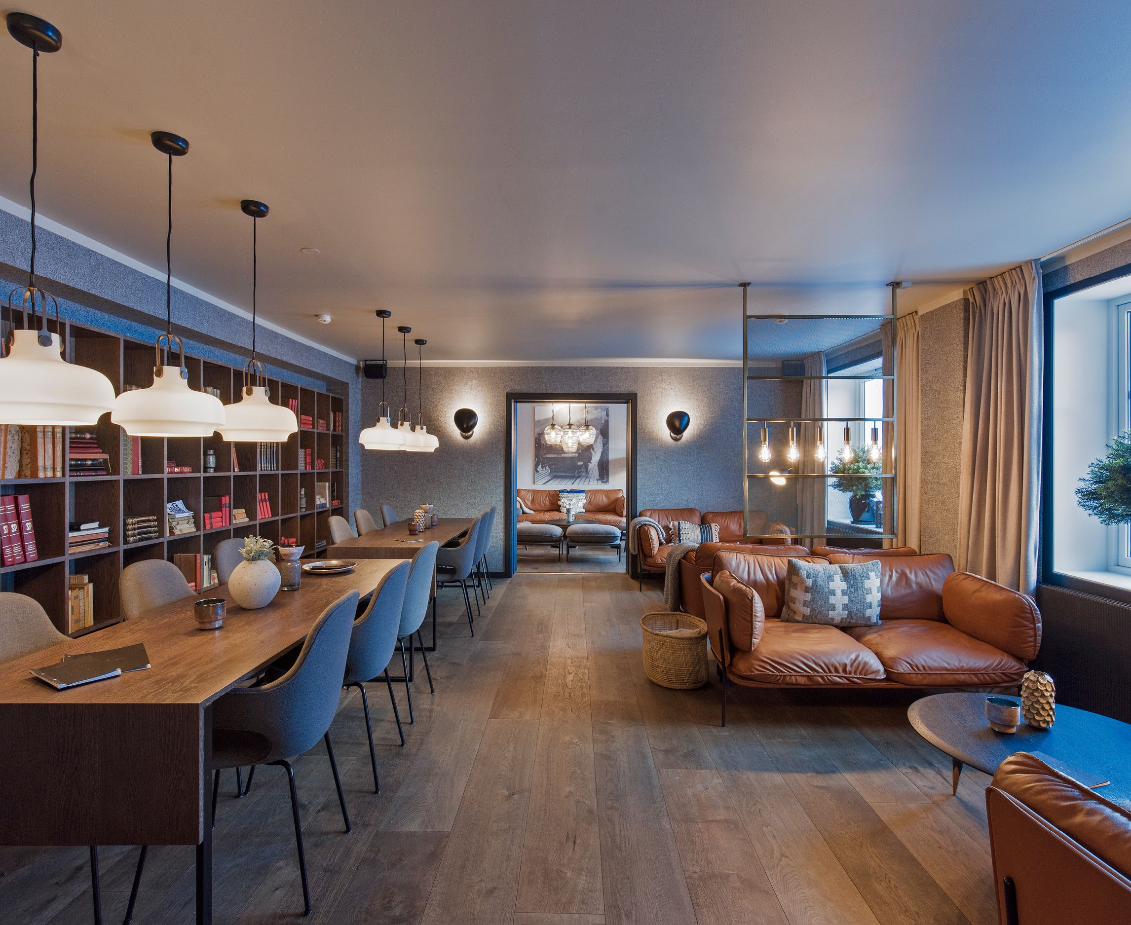 A library with sofas, chairs and tables