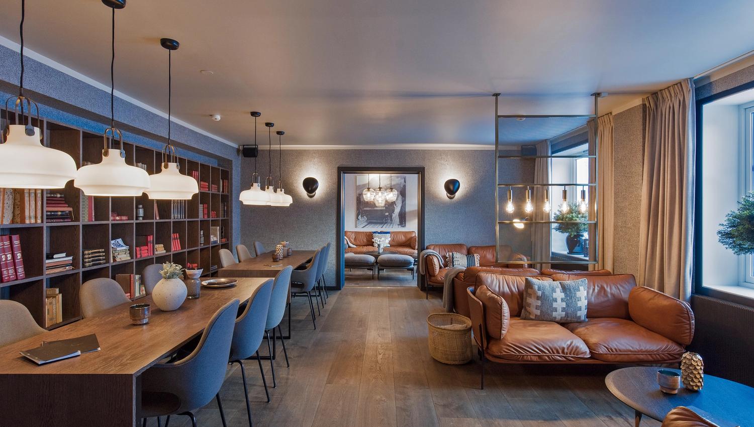A library with sofas, chairs and tables