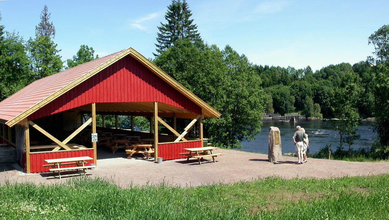 A red stilt house by the waterfall