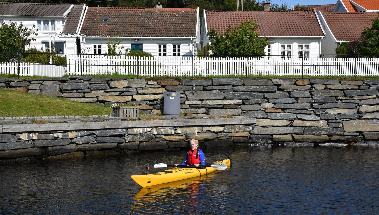 En person i en gul kajakk som padler i Spangereidkanalen