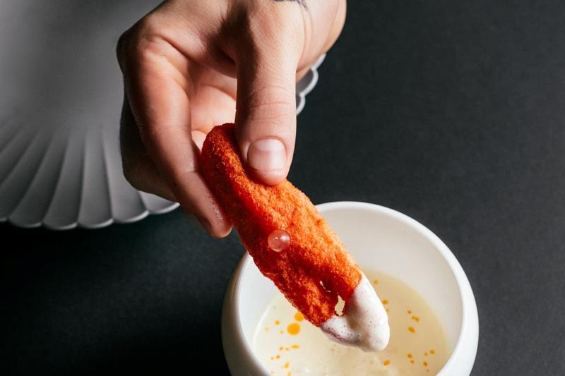 chef dipping a dish 