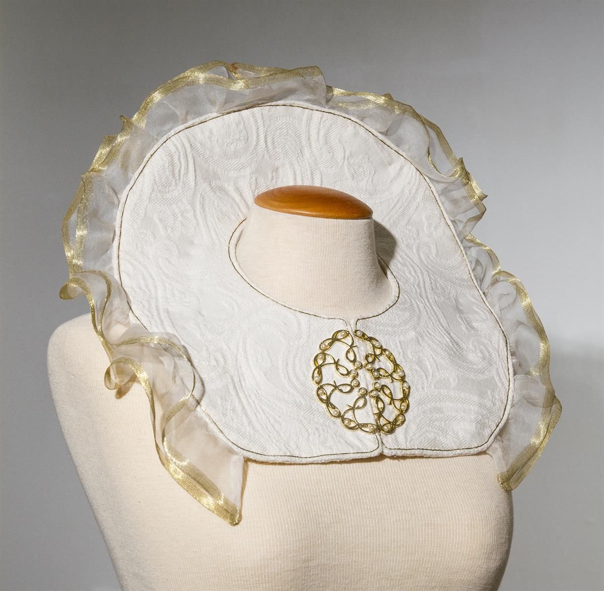 Jewelry artwork with white and translucent elements displayed on a mannequin.
