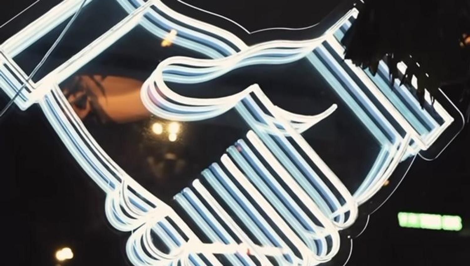 håndslag logo i neon