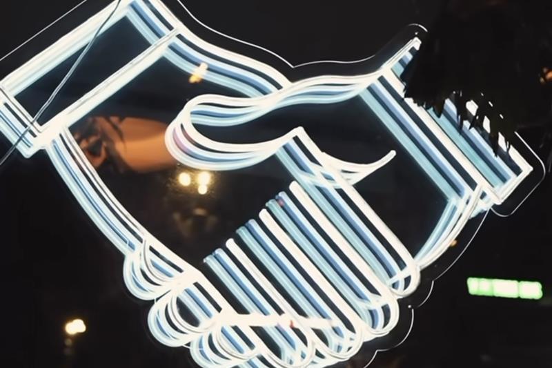 håndslag logo i neon